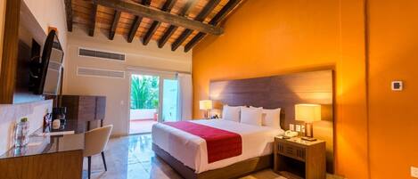 A hotel room with a bed, bedside tables, a desk, and a chair.