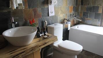 A bathroom with a large white sink, a toilet, and a bathtub.