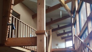A wooden staircase with a view of the upper floor. - Hakuba Alpine Hotel (Hakuba)