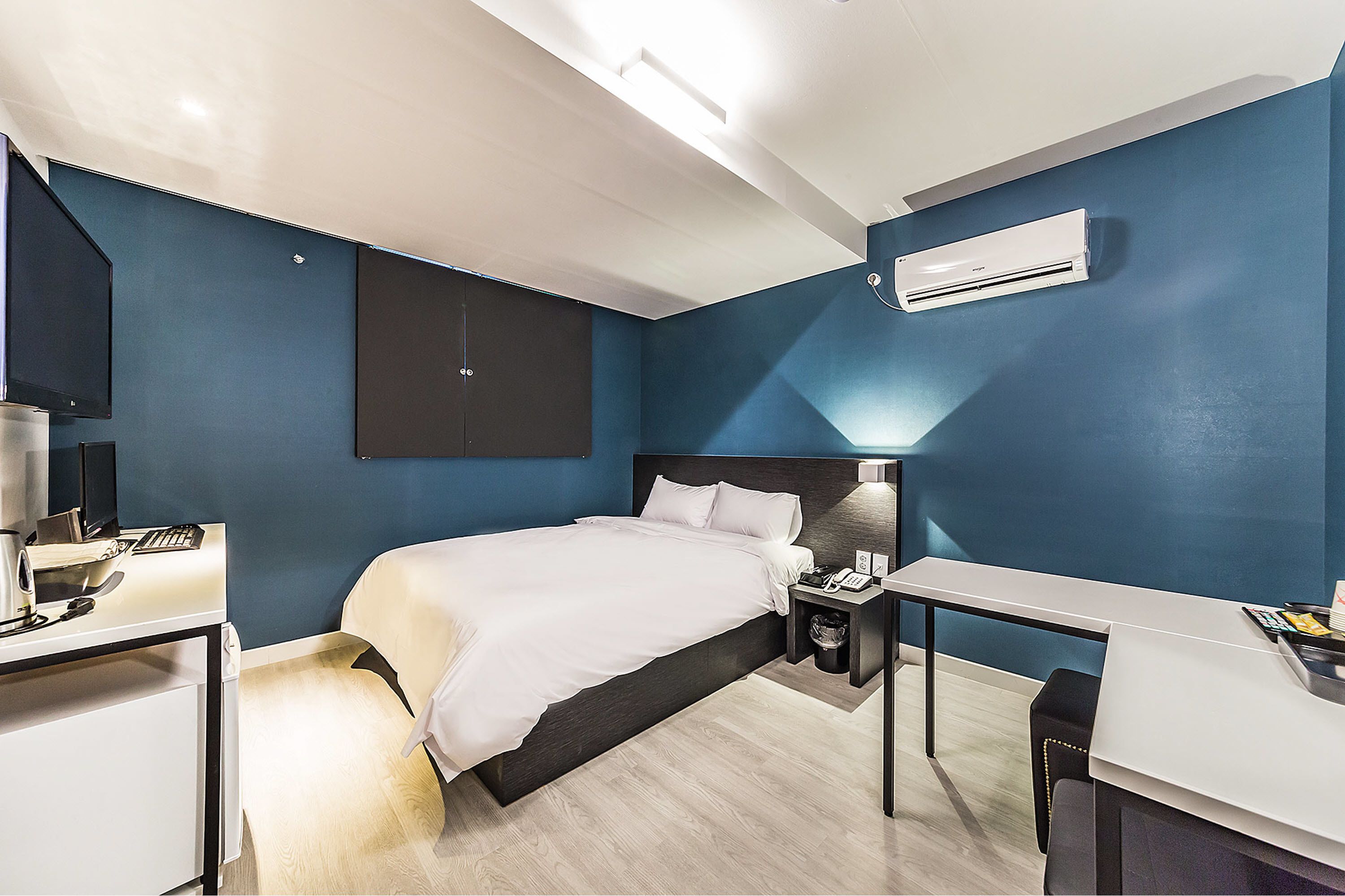 Una habitación de hotel moderna con cama, escritorio y zona de estar.