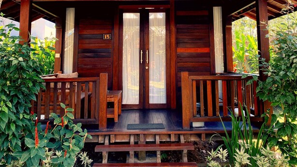 A wooden cabin with a porch, two doors, and a number '15' sign. - D' Padang (Pecatu)