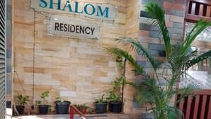 A stone wall with a sign reading "SHALOM RESIDENCY". - Shalom Residency (Kanayannur)
