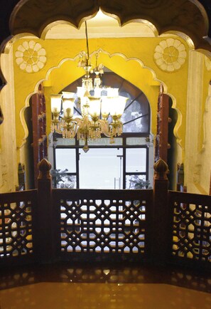 An ornate entrance with a chandelier, a decorative arch, and a lattice gate. - Shanti Bhawan Heritage Hotel (Jodhpur)