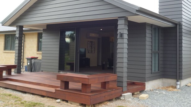 A modern house with a covered porch and a chimney. - Glencairn Beauty (Twizel)