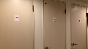Three doors with a "WOMEN" sign above each, indicating women's restroom facilities. - bnb+ Akihabara - Hostel, Caters to Women (Tokyo)
