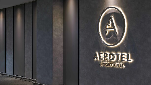 A modern hotel sign with a circular logo and the name "AEROTEL AIRPORT HOTEL". - Aerotel Kuala Lumpur (Sepang)