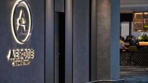 A modern hotel entrance with a prominent logo and name. - Aerotel Kuala Lumpur (Sepang)