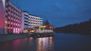 A waterfront hotel with a modern design, featuring a curved glass facade and a flat roof. - The Regency Waterfront Hotel (Kuala Terengganu)