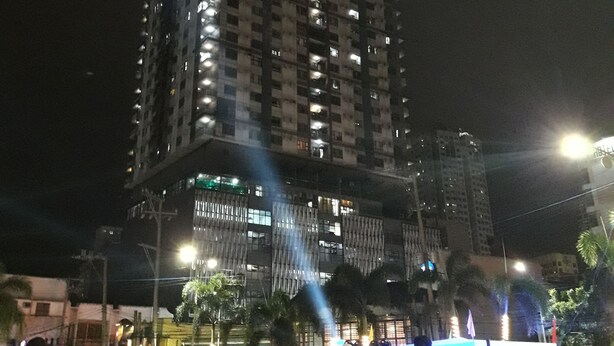 A high-rise building with multiple floors and illuminated windows at night. - Manila Lee - Malate Bayview Mansion (Manila)