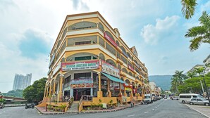 A multi-story building with a prominent Danish Briyan House sign, featuring a staircase leading to the entrance. - Hotel O Ferringhi Stay Iinn (George Town)