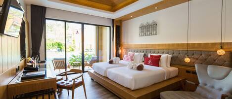 A modern hotel room with a large bed, a desk, and a comfortable chair.
