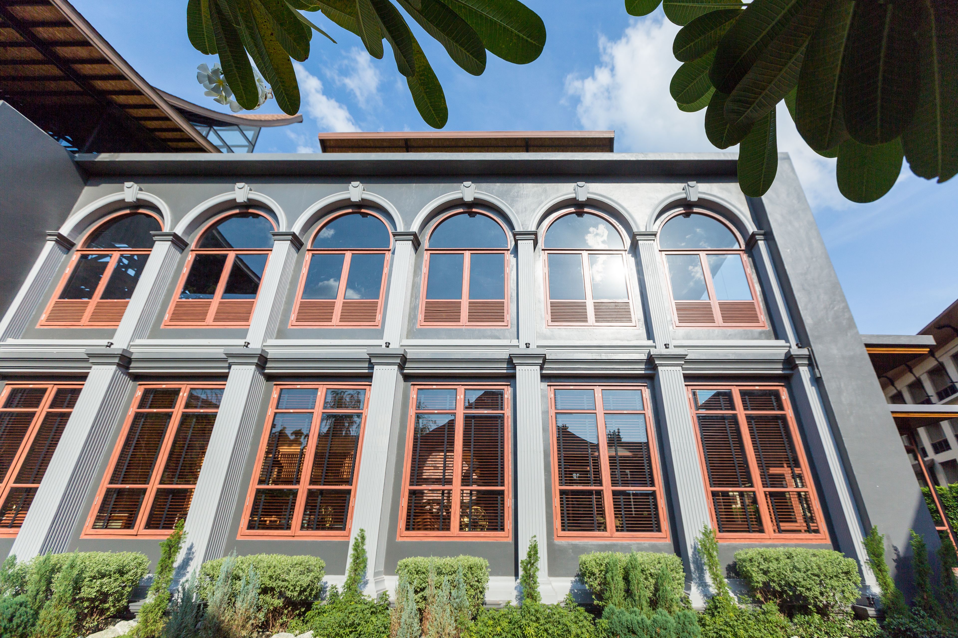 A building with multiple arched windows and a flat roof.