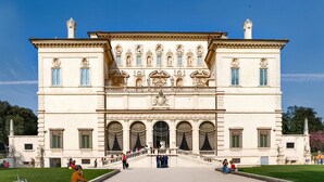 A large, classical building with a central staircase, arched windows, and statues. - Via Veneto Luxury Suites (Rome)
