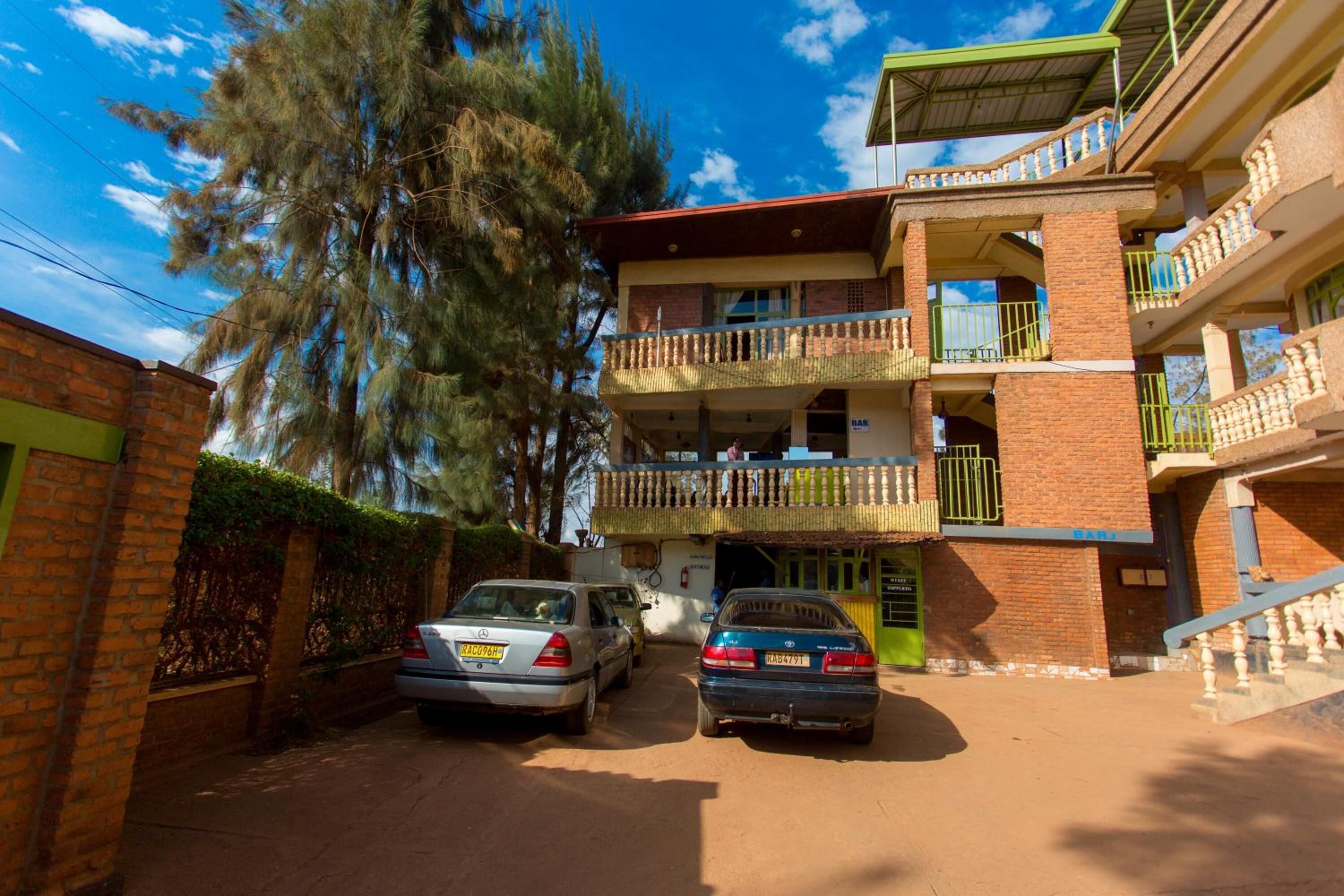 Un edificio de varios pisos con fachada de ladrillo, varios balcones y un acceso cubierto.
