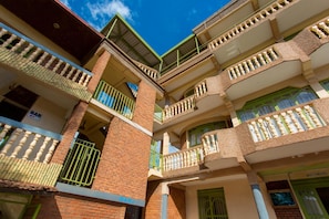 A multi-story building with balconies, a bar, and a restaurant.