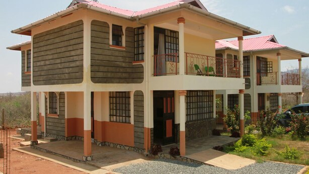 A two-story house with a balcony, a porch, and a garage.