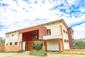 A modern two-story building with a flat roof, large windows, and a brick facade. - Orient Park Hotel (Kigali)