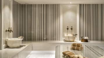 Bathroom features a large bathtub, sink, and ample toiletries.