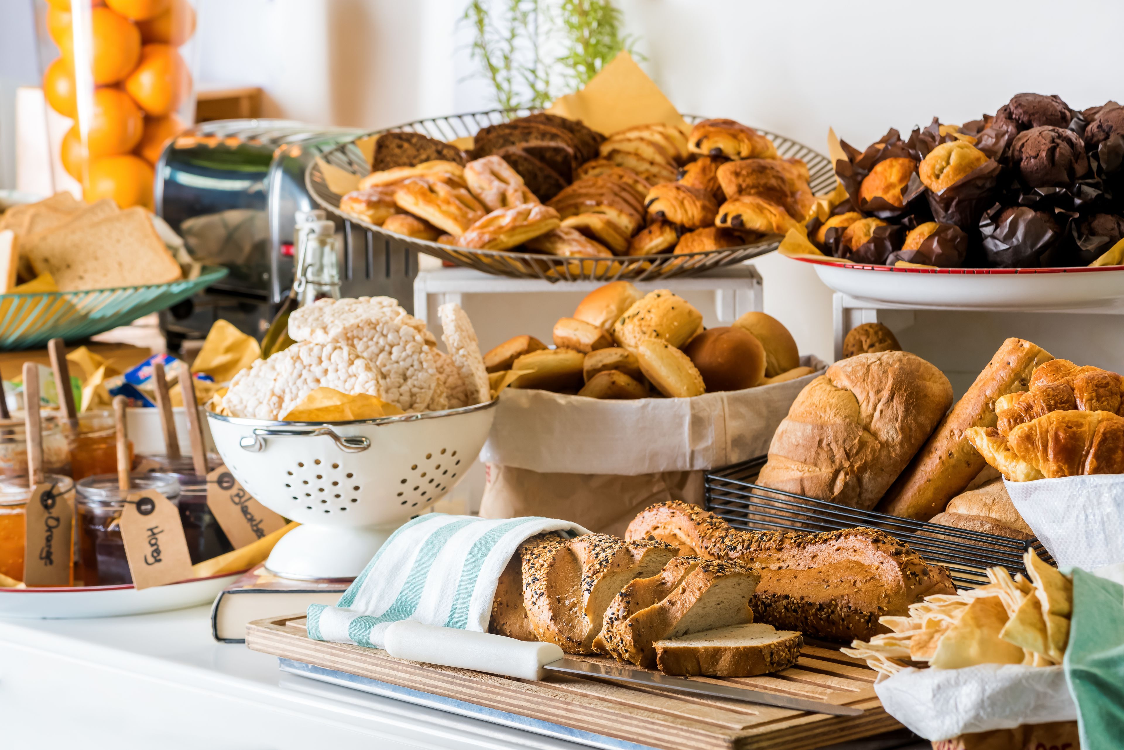 A variety of breads and pastries displayed on a table.