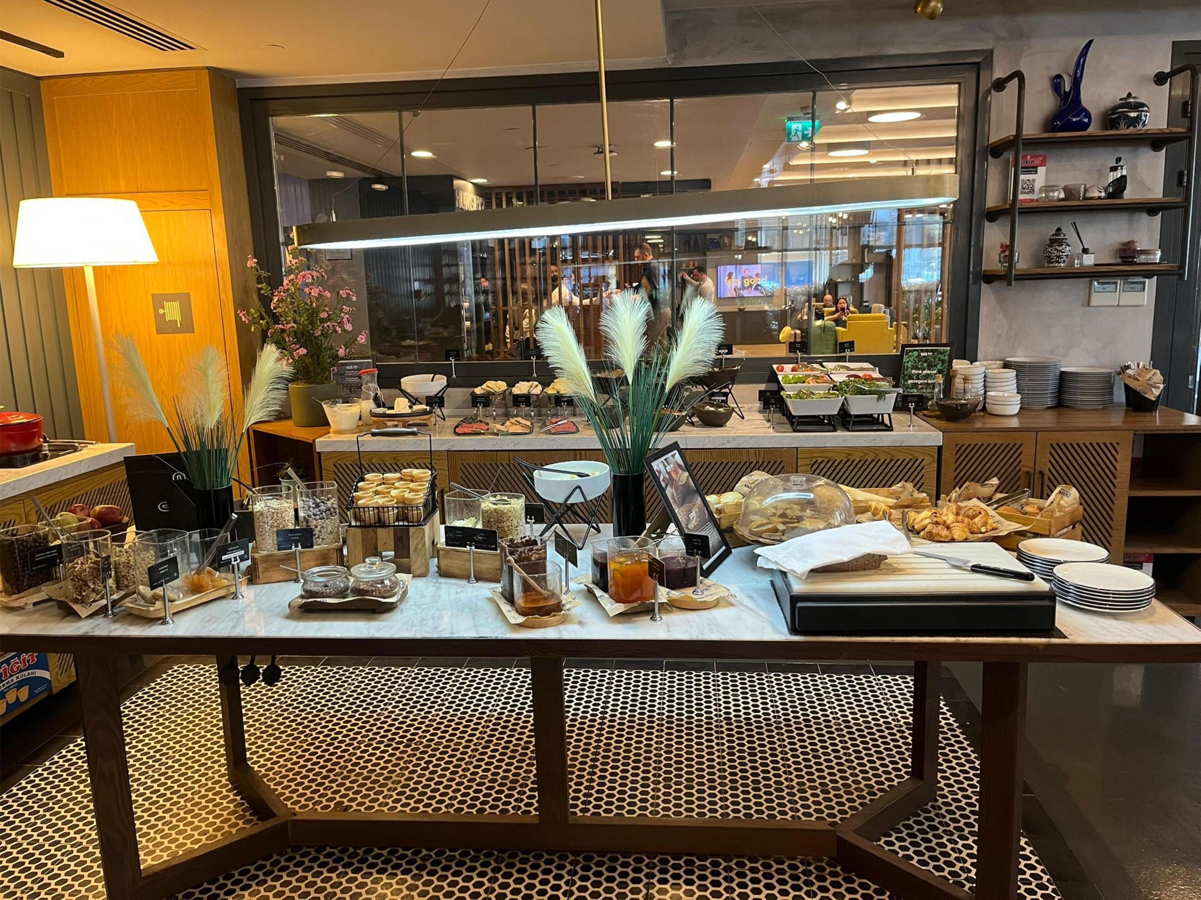 A buffet setup with various food items and a decorative centerpiece.