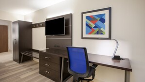A modern office space with a desk, chair, and built-in TV. - Holiday Inn Express & Suites Atlanta N - Woodstock by IHG (Woodstock)
