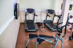A gym with treadmills, a bench, and weight equipment. - Lekki Heights Hotel (Lekki)