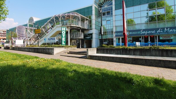 A modern hotel with a glass facade, a prominent entrance, and a staircase leading to the lobby. - Hotel Europa (Biella)