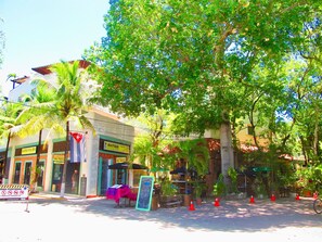 A storefront with a sign reading "Boutique" and a chalkboard with writing.