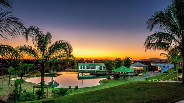A resort with a pool, a restaurant named 'Fumao Spark', and a green tent structure. - Ramada by Wyndham Furnaspark (Formiga)