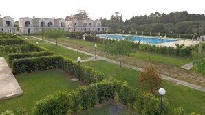 A hotel with a swimming pool, well-maintained gardens, and a view of the surrounding area. - Blumare Hotel & Residence (Otranto)