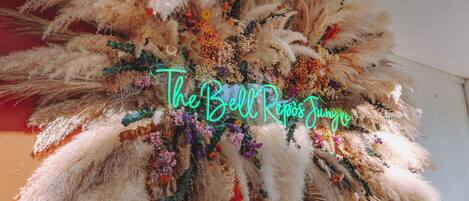 Una composición decorativa con un letrero de neón que dice 'The Bell of Rio'.
