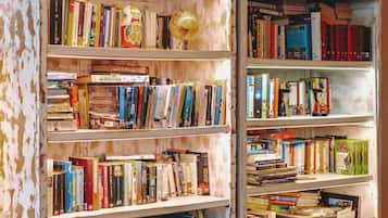 A room with two large bookshelves filled with books and various decorative items.