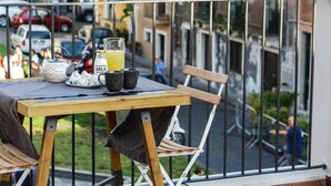 A balcony with a table set for breakfast, including a kettle, cups, and a milk jug. - Sciara Larmisi (Catania)
