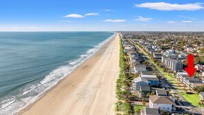 A coastal residential area with a beach, houses, and a road. - Private pool and gorgeous beach house, steps from the ocean! (Surfside Beach)