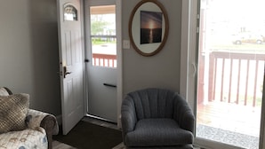 A room with a door, a chair, a rug, and a picture on the wall. - GORGEOUS BEACH HOUSE, TOP LOCATION! WALK TO BEACH, ICE CREAM, EATERIES. DOGS OK (Brigantine)