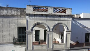 A building with a white facade, two visible arches, a balcony with a metal railing, and a sign that reads "FARMACIA". - Pompei, Vesuvio and Naples bay view (Trecase)