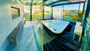 A modern spa with a glass-enclosed hot tub, a tiled floor, and a view of the outdoors. - I L❤️VE U! Villa. Sea view! SPA! Heated Pool! Cinema! Private Chef! (Ericeira)