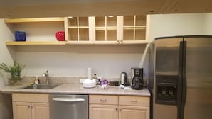 A kitchen with a stainless steel dishwasher, a refrigerator, a coffee maker, and a sink. - 3 bed 2 bath home in heart of Silicon Valley (Redwood City)