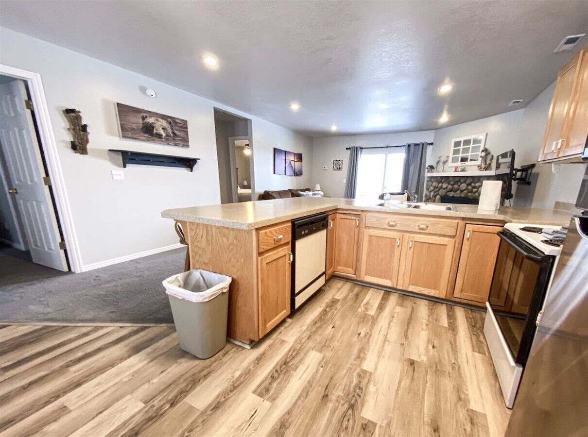 A modern kitchen with wooden cabinets, a dishwasher, and a countertop.