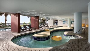 A pool area with hot tubs, lounge chairs, and a tiled floor. - Last Minute Rate, Direct Oceanfront 4BR/3BA, Sleep 16, Central Location (Myrtle Beach)