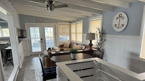 A spacious kitchen with a dining area, a large window, and a ceiling fan. - Steps from beach access, family friendly home with all the amenities! (Milton)