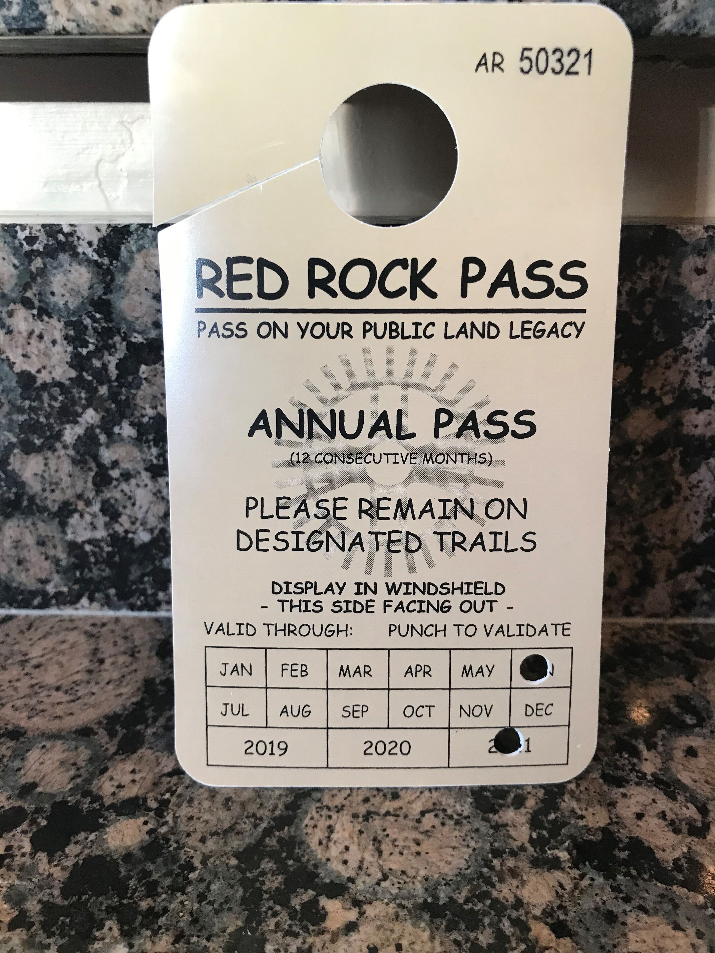 A Red Rock Pass annual pass tag with a punch-out validation hole.