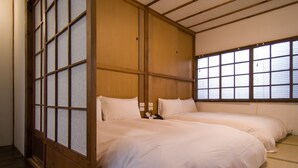 A traditional Japanese-style room with tatami flooring, a sliding shoji screen, and a large window. - 22alleys (Magong)