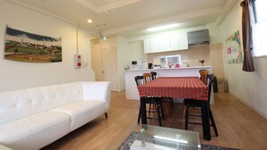 A modern apartment with a living room, dining area, and kitchen. - JQ Villa Okinawa Yaka (Kin)