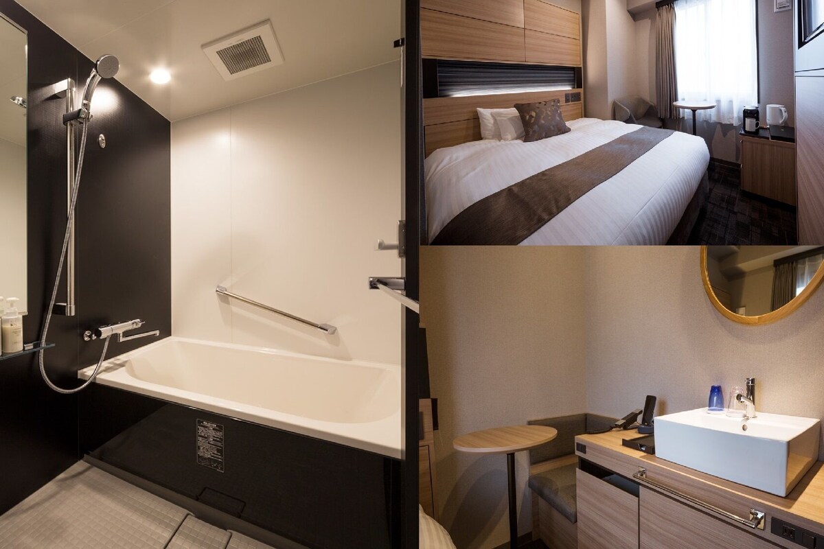 A modern bathroom with a bathtub, a shower, and a vanity with a sink.