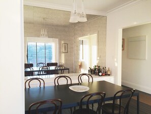 Enjoy meals in this dining area with a large table and six chairs, surrounded by a city view.