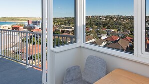 Un balcon offrant une vue dégagée sur un quartier résidentiel et un plan d’eau.
