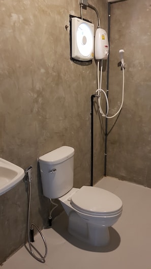 A bathroom with a toilet, a bidet, and a shower. - A-Mote Loft at Phitsanulok (Phitsanulok)