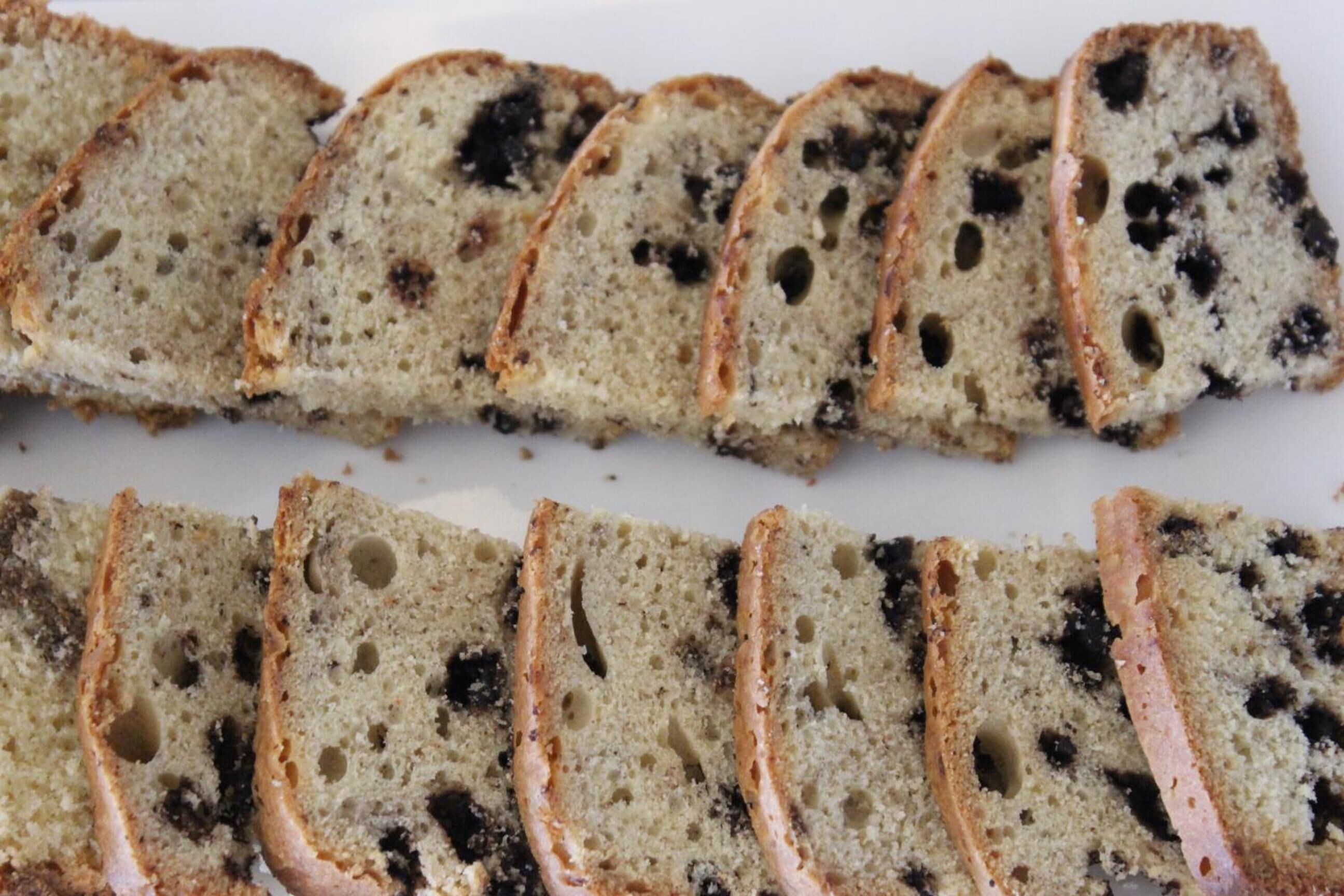 Slices of bread with visible seeds and a crusty exterior.