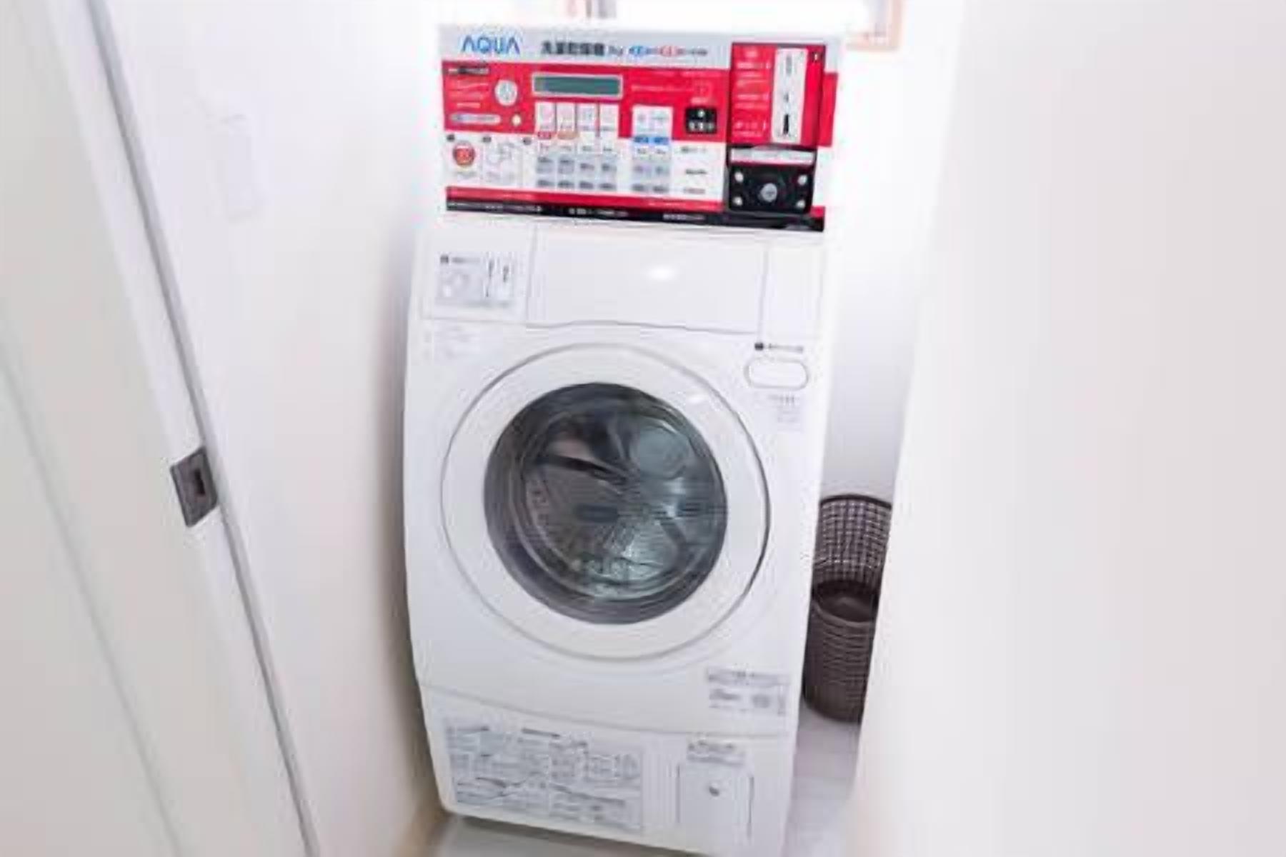 A front-loading washing machine with a control panel and a basket.